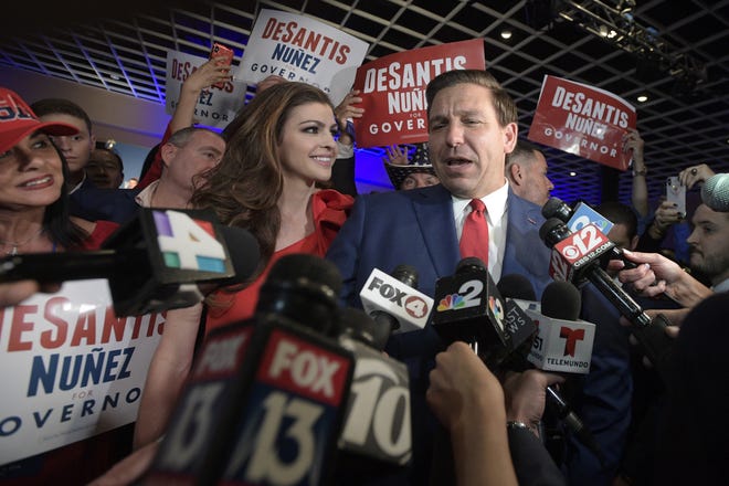 Florida Gov.-elect Ron DeSantis, right, answers questions from reporters with his wife, Casey, on election night in Orlando. The transition team for the incoming administration of DeSantis and Lt. Gov.-elect Jeanette Nuñez announced Friday that Cynthia Kelly will remain as the director of Office of Policy and Budget and Melinda Miguel will return as the state’s chief inspector general. [AP Photo/Phelan M. Ebenhack]