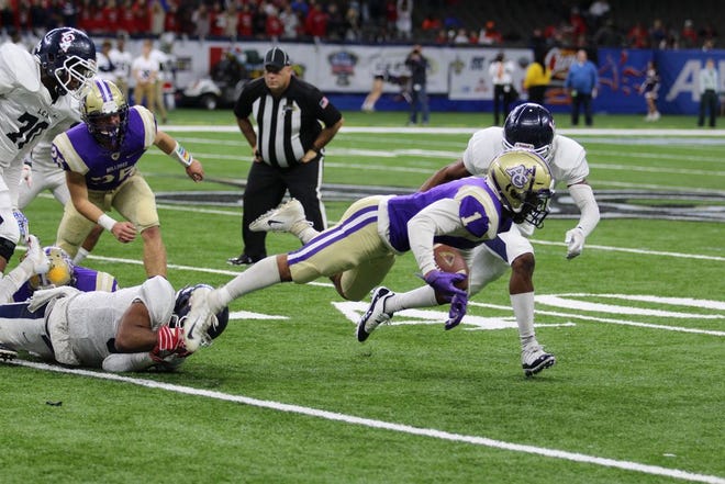 Bulldog running back Jamar Barber is tripped up during Ascension Catholic's state title loss to Lafayette Christian. Photo by Kyle Riviere.