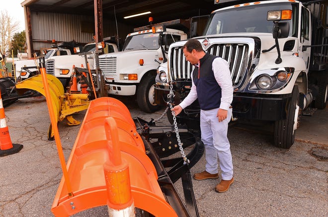 Jay Squires, streets and storm water manager with the city of Spartanburg Public Works, checks over a snow plow in preperation for the upcoming weather. The city has already applied brine to roads in some critical areas. [TIM KIMZEY/Spartanburg Herald-Journal]
