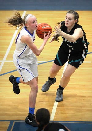 Quincy's Allison McMorrow heads to the hoop as Plymouth South's Emily Hoar defends as Quincy hosts Plymouth South in high school girl's basketball,Tuesday, Dec. 13, 2016. Gary Higgins/The Patriot Ledger