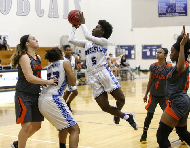 North Port High's Emani Jefferson (5) goes to the basket against Sarasota High Friday night in the North Port High gymnasium. [Herald-Tribune photo / Tom O'Neill]