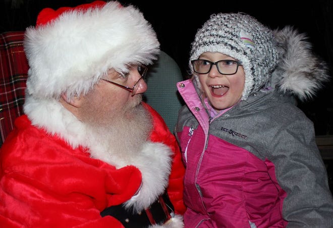Tenley Schuler, 5, had plenty to share with Santa on Friday at “Christmas in Colon.” A parade, carols and a tree-lighting ceremony were also a part of the evening.