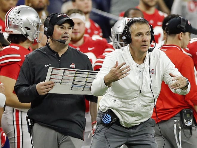 Ohio State Buckeyes head coach Urban Meyer coaches while Ohio State Buckeyes offensive coach Ryan Day calls a play against Northwestern Wildcats during the Big Ten Championship game in Indianapolis, Ind on December 1, 2018.