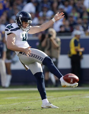 FILE - In this Sunday, Nov. 11, 2018 file photo, Seattle Seahawks punter Michael Dickson (4) punts the ball downfield during the first half in an NFL football game against the Los Angeles Rams in Los Angeles. Spending a draft pick on a punter isnâ€™t unusual in the NFL because field position still matters in the league. When that rookie comes in and shows off a booming leg, people take notice.Michael Dickson bypassed his final year of eligibility at Texas to enter the draft early, and the Seattle Seahawks traded up in the fifth round to take the Australian native and 2017 Ray Guy Award winner. (AP Photo/Alex Gallardo, File)