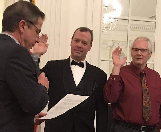 Knox County Clerk Scott Erickson, center, takes the oath of office as president of the Illinois Association of County Officials with Vice President Mike Iwanicki, right, from the Veterans Assistance Commissions. The oath is being administered by Past President Chris Kachiroubas, DuPage County circuit clerk. [SUBMITTED PHOTO]