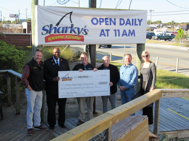 Sharky’s donated all of its proceeds from Nov. 29 to the Empty Stocking Hurricane Relief Fund. Pictured, left to right, are Neel Bennett of Sharky’s, Salvation Armey Maj. Otis Childs, Grant Wittstruck, ESF co-chairman Floyd Skinner, Derrick Bennett of Sharky’s and Kami Viers of Sharky’s. [MICHAEL McCABE/THE NEWS HERALD]