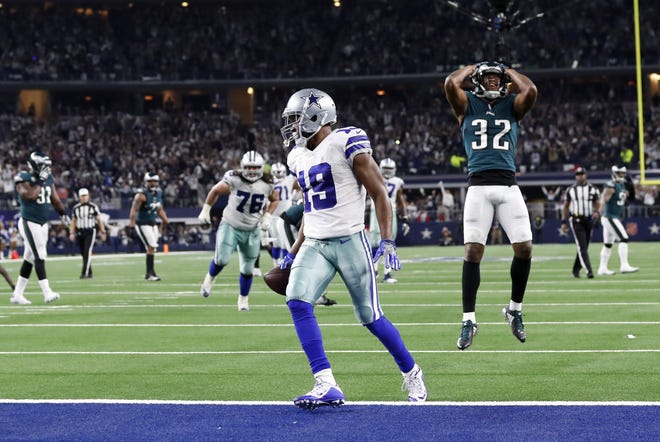 Dallas' Amari Cooper steps into the end zone with a 15-yard touchdown in overtime as Philadelphia's Rasul Douglas shows his dismay Sunday. [Roger Steinman/The Associated Press]