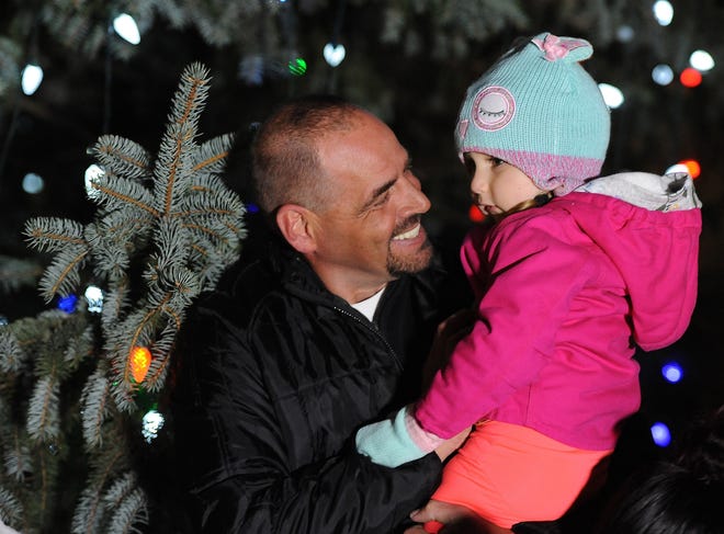 Fall River director of community maintenance John Perry thriess to coax his Goddaughter, Arian Tavares, 3, into saying hello to Santa at the city tree lighting Monday, December 3, 2018, in Fall River, Massachusetts. [Herald News Photo | Jack Foley]