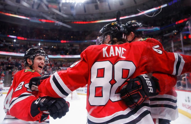 Chicago Blackhawks right wing Patrick Kane celebrates with teammates after scoring against the Montreal Canadiens during the second period Sunday, Dec. 9, 2018, in Chicago. [KAMIL KRZACYNSKI/THE ASSOCIATED PRESS]
