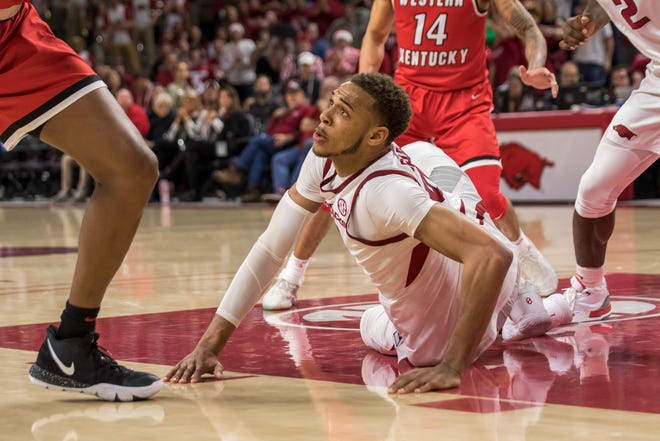 Arkansas sophomore Daniel Gafford falls to the floor in the final minute against Western Kentucky on Saturday at Bud Walton Arena in Fayetteville. [CRANT OSBORNE/SPECIAL TO NATE ALLEN SPORTS SERVICE]
