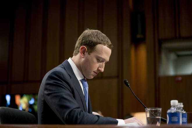 FILE- In this April 10, 2018, file photo Facebook CEO Mark Zuckerberg pauses while testifying before a joint hearing of the Commerce and Judiciary Committees on Capitol Hill in Washington about the use of Facebook data to target American voters in the 2016 election. The British Parliament has released some 250 pages worth of documents that show Facebook considered charging developers for data access. The documents show internal discussions about linking data to revenue. (AP Photo/Andrew Harnik, File)