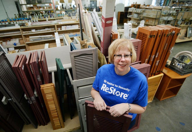 Nancy Milkowski, executive director of Greater Erie Area Habitat for Humanity, stands amid shutters and other building supplies inside the Habitat for Humanity ReStore in Millcreek Township on Thursday. A large variety of new and used items are sold there. The organization is in need of building materials, new and used tape measures, work gloves and home goods. [GREG WOHLFORD/ERIE TIMES-NEWS]
