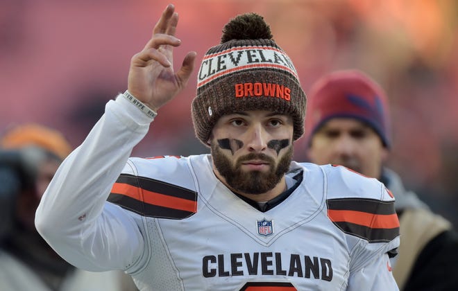 Cleveland Browns quarterback Baker Mayfield walks off the field after the Browns defeated the Carolina Panthers on Sunday in Cleveland. [ASSOCIATED PRESS]