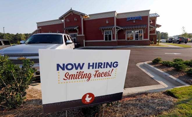This July 25, 2018, file photo shows a help wanted sign at a new Zaxby's restaurant in Madison, Miss. On Monday, Dec. 10, the Labor Department reports on job openings and labor turnover for October. (AP Photo/Rogelio V. Solis, File)
