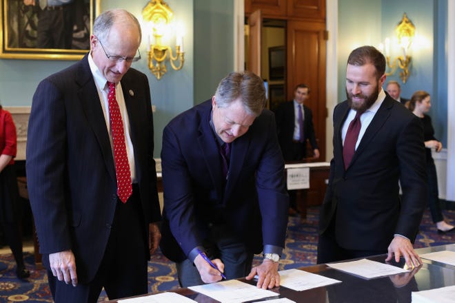 Rep. Roger Marshall, R-Kan., signs the 2018 Farm Bill Conference Report alongside House Agriculture Committee Chairman Mike Conaway, R-Texas. [COURTESY]