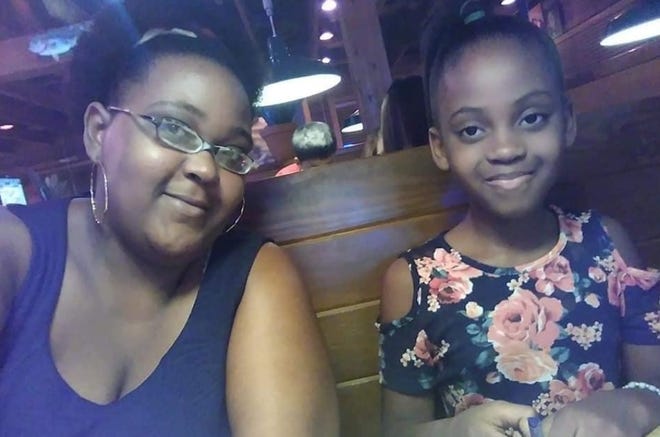 McKenzie Adams, 9, has dinner with her mother, Jasmine Adams-Head. [FAMILY PHOTO]