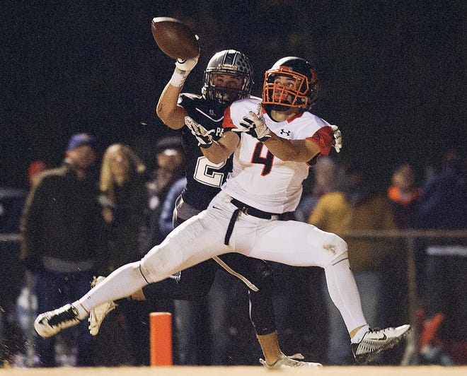 North Davidson receiver Mason Everhart catches a touchdown pass despite tight coverage by Ledford's Coleman Reich in last Friday's 24-7 Eastern N.C. 2AA playoff victory. [Donnie Roberts/The Lexington Dispatch]