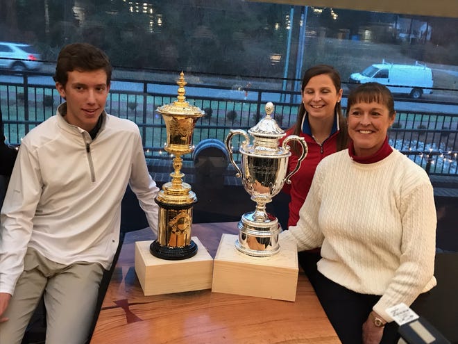 Pinehurst's Jackson Van Paris, left, USGA Senior Open manager Katherine Thigpen, center, and Donna Andrews pose with trophies from the U.S. Amateur and U.S. Senior Women's Open Championship. Both events will be held on Sandhills area courses in Moore County next year. Andrews, a teaching pro at Pine Needles, will play in the women's event, while Van Paris became the second-youngest player to win a match-play match at last year's Amateur. [Sammy Batten/The Fayetteville Observer]