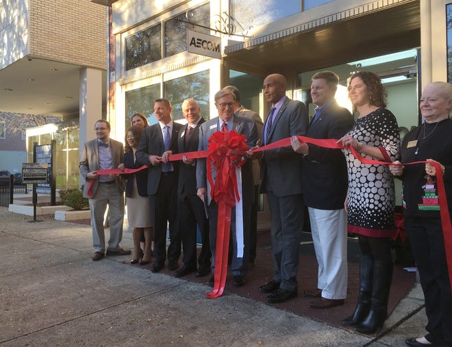 Community leaders join executives from AECOM in a ribbon-cutting ceremony at the engineering and consulting firm's new office in downtown Augusta on Tuesday. [DAMON CLINE/THE AUGUSTA CHRONICLE]