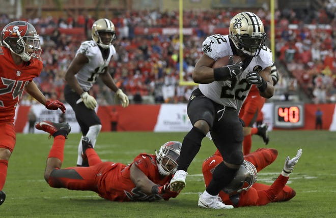 New Orleans Saints running back Mark Ingram (22) breaks through the Tampa Bay Buccaneers defense on a 17-yard touchdown run during the second half Sunday, in Tampa, Fla. [The Associated Press]