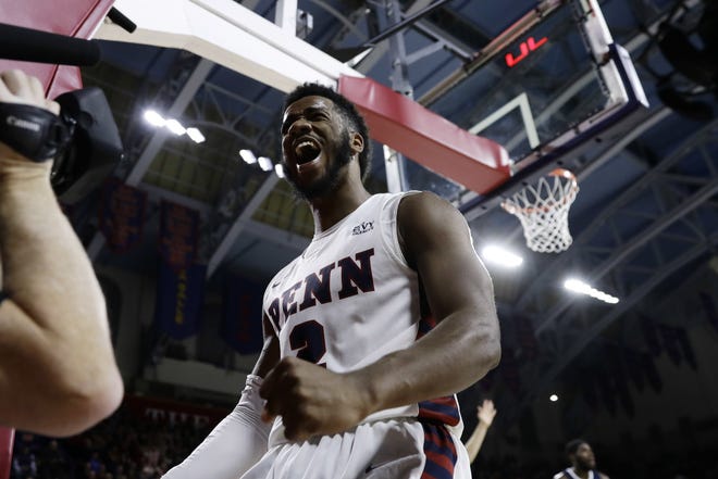 Penn's Antonio Woods reacts after drawing a foul during the second half of Tuesday night's game against Villanova at the Palestra in Philadelphia. Penn won 78-75. [MATT SLOCUM / THE ASSOCIATED PRESS]