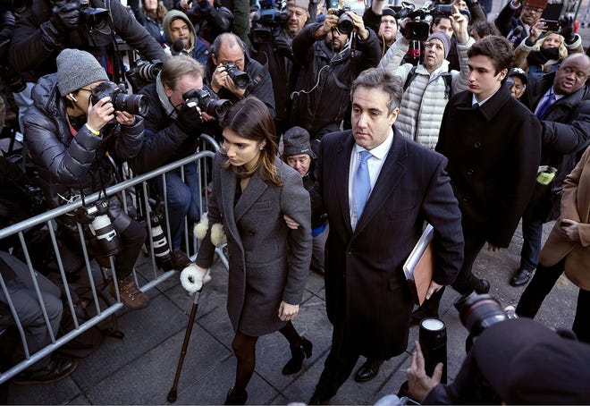 Michael Cohen, center, President Donald Trump's former lawyer, accompanied by his children Samantha, left, and Jake, right, arrives at federal court for his sentencing, Wednesday in New York, for dodging taxes, lying to Congress and violating campaign finance laws. [CRAIG RUTTLE/ASSOCIATED PRESS]
