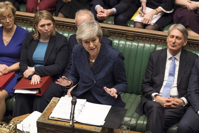 Britain's Prime Minister Theresa May speaks during the regular scheduled Prime Minister's Questions inside the House of Commons in London Wednesday. May survived a political crisis over her Brexit deal Wednesday, winning a no-confidence vote by Conservative lawmakers that would have ended her leadership of party and country. [MARK DUFFY/UK PARLIAMENT/ASSOCIATED PRESS]