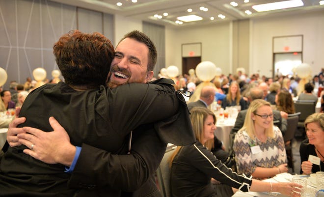 Oak Park music teacher Shane Swezey gets a big hug from Edwina Oliver, former principal of Oak Park School, after Swezey was named Sarasota County's 2019 Teacher of the Year by the Education Foundation of Sarasota County at a luncheon Wednesday in Sarasota.  [Herald-Tribune staff photo / Mike Lang]
