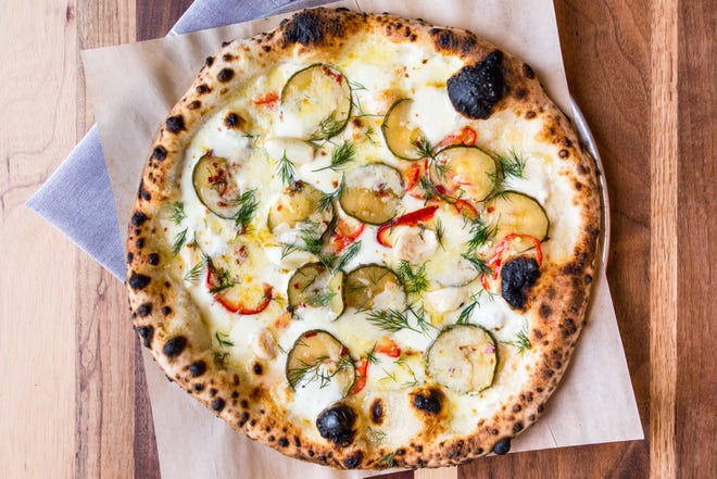 Spicy pickle pizza with La Barbecue housemade pickles, mozzarella, fontina and Parmesan cheeses, La Barbecue pickled garlic, fresno chilies and dill. [Contributed]