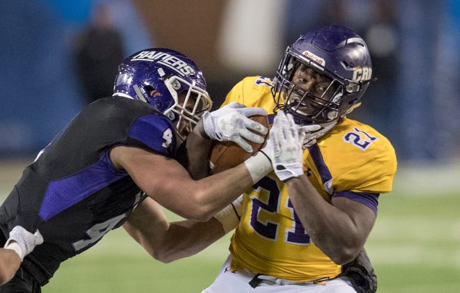 FILE - In this Dec. 15, 2017, file photo, Mount Union's Danny Robinson (4) tackles Mary Hardin-Baylor's Markeith Miller (21) during the Amos Alonzo Stagg Bowl NCAA Division III college football championship, in Salem, Va. Robinson and Miller were named to The Associated Press Division III All-America Team, Thursday, Dec. 13, 2018. (AP Photo/Lee Luther Jr., File)