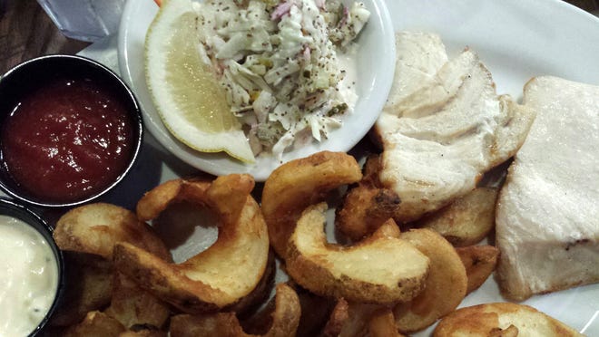 As the catch of the day, the swordfish offered a thick slice of seafood, coleslaw and side-winder fries. [SHARON DOOLEY/CONTRIBUTING WRITER]