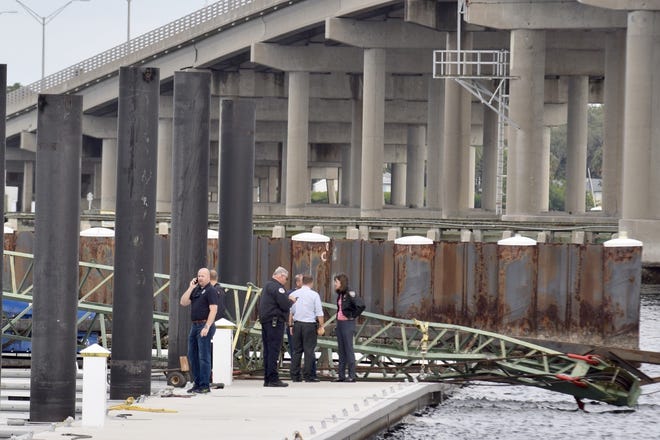 More than 50 people helped lift a collapsed crane off a construction worker Thursday at Twin Dolphin Marina in Bradenton, but the worker died of his injuries. [Herald-Tribune staff photo / Carlos R. Munoz]