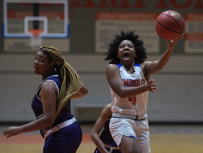 Southeast's Ce'mya Brooks goes to the basket behind Booker's Miah Lowman during Thursday night's game at Southeast High School. Southeast won the game 64-60. [HERALD-TRIBUNE STAFF PHOTO / DAN WAGNER]