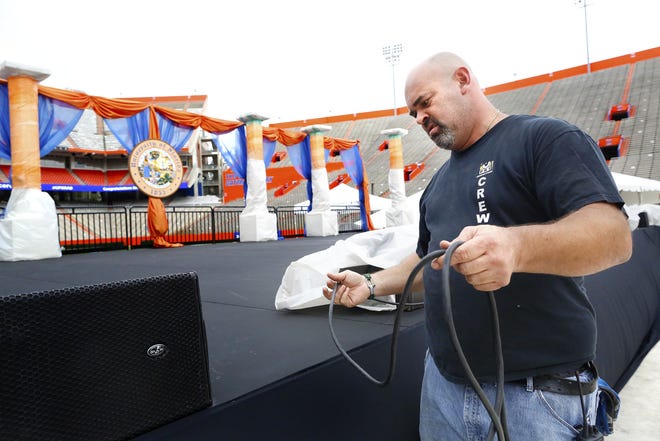 Chris Hoskins, with PRI Productions, works to set up the sound system for the University of Florida fall commencement ceremony that will take place in Ben Hill Griffin Stadium this weekend, in Gainesville Dec. 13, 2018. [Brad McClenny/The Gainesville Sun]