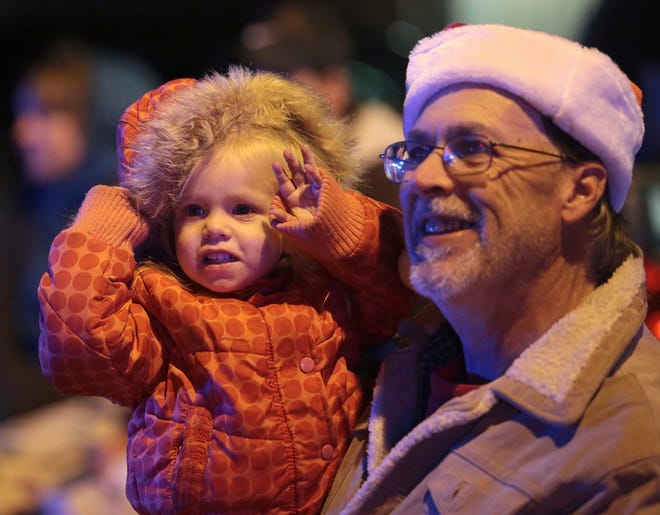 Reagan Nabors, 1, watches the Panama City Jaycees Christmas Parade with her grandfather, Jeff Barnes, in December 2017. [HEATHER HOWARD/NEWS HERALD FILE PHOTO]