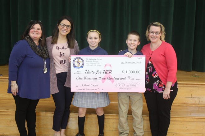 Students at St. Katharine Drexel Catholic School in Northampton recently raised $1,300 for the breast cancer support nonprofit Unite for HER. Through various events like dress down days, bake sales and pink ribbon pin sales, the students raised the money in honor of St. Katharine sixth-grade teacher Karin Kane, a breast cancer survivor. The students raised the funds through dress down days, bake sales and pink ribbon pin sales. Each month the student council chooses a charity and holds various fundraisers to raise funds or collect goods for the organization. In May, Kane had her final treatment and in returned to teaching in September. The check was presented to Unite for HER Special Events Manager Cameron Cotrufello during a recent event at the school. Pictured from left are St. Katharine Principal Laura Clark, Cotrufello, students Abigail Kuvik and Cody Brodt and Kane. [CONTRIBUTED]