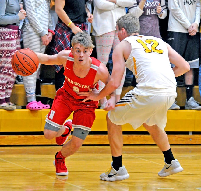 Norwayne's Ben Draper (left) drives baseline around Waynedale defender Philip Brewer in a Wayne County Athletic League game Friday in Apple Creek. Draper scored 21 points to help the Bobcats to a 54-52 road win.
