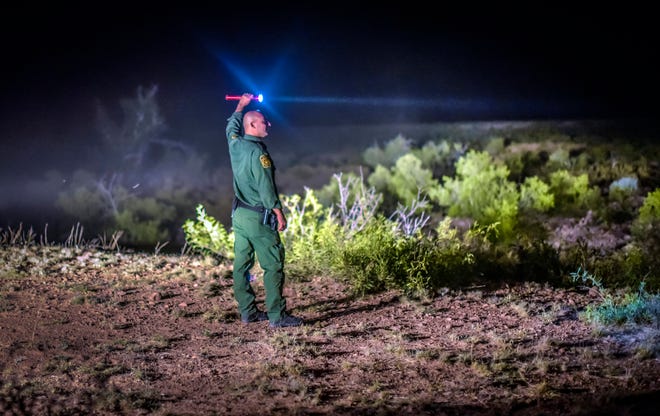 FILE - In this June 24, 2015, file photo, a Border Patrol agent looks for other agents in the Animas mountains in New Mexico's boot heel. A 7-year-old Guatemalan girl, picked up with her father and dozens of other migrants along the remote stretch of the U.S.-Mexico border, has died, federal officials said Friday, Dec. 14, 2018. (Roberto E. Rosales/The Albuquerque Journal via AP, File)