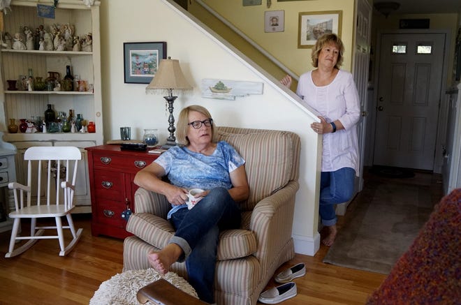 Donnie Anderson, seated, and Debbie Jamieson at their home in North Kingstown. As Donnie transitions to a woman, their relationship continues to evolve. [The Providence Journal / Kris Craig]