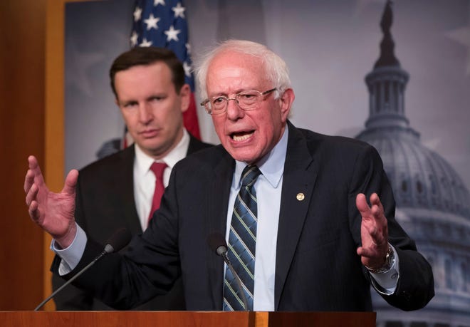 Sen. Bernie Sanders, I-Vt., joined at left by Sen. Chris Murphy, D-Conn., holds a news conference after the Senate passed a resolution he introduced that would pull assistance from the Saudi-led war in Yemen, a measure to rebuke Saudi Arabia after the killing of journalist Jamal Khashoggi, at the Capitol in Washington, Thursday, Dec. 13, 2018. (AP Photo/J. Scott Applewhite)