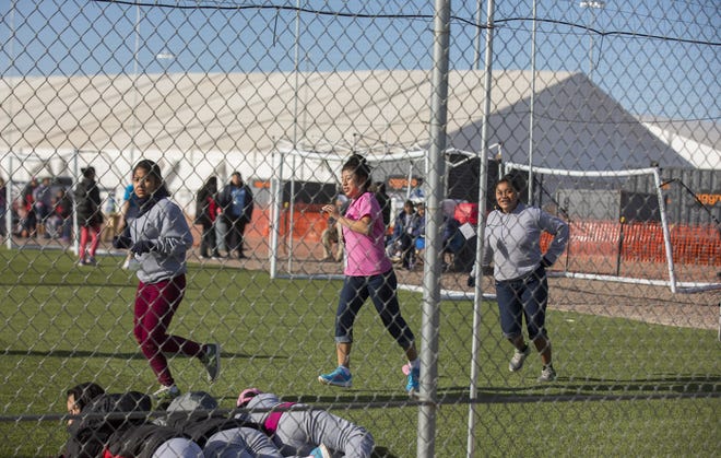 Migrant teens held at the Tornillo detention camp run inside the tent city in West Texas last month. [Ivan Pierre Aguirre via AP]