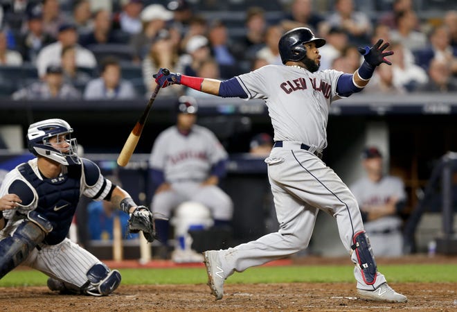 Carlos Santana (hitting a homer for Cleveland in the 2017 playoffs) is heading back to the Indians because of a trade that also involved slugger Edwin Encarnacion. [Kathy Willens/The Associated Press]