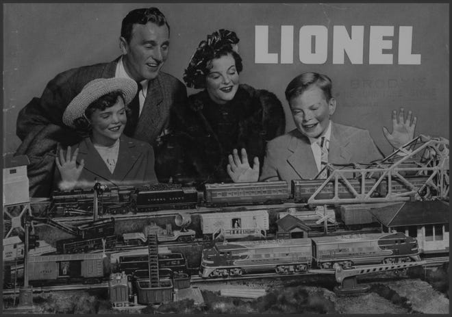 Model train display thrilled this happy family. It was 1944. [PHOTO COURTESY OF LIONEL]