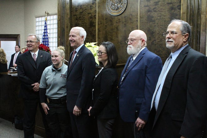 From left, 5th Judicial District Circuit Judge Gordon McCain, Arkansas Community Corrections officer Stephanie Thomas, Arkansas Gov. Asa Hutchinson, Franklin County Drug Court Administrative Specialist Brittany Meadors, Drug Court Counselor Larry Baker and area Community Corrections Area Manager Kent Kamm pose for a photo during the Franklin County Drug Court dedication Friday, Dec. 14, 2018, at the Franklin County Courthouse. [MAX BRYAN/TIMES RECORD]