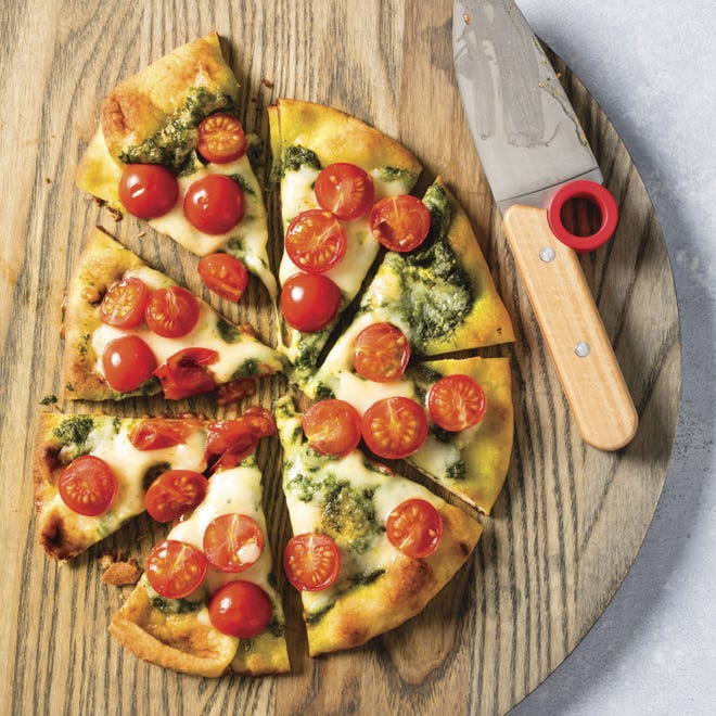 This Pizza in a Flash recipe appears in the "Complete Cookbook for Young Chefs." [Steve Klise/America's Test Kitchen via AP]