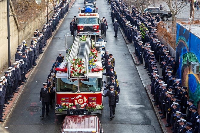 The funeral procession headed from St. John's to Notre Dame Cemetery for Christopher Roy was led by his engine, Ladder 4, and Ladder 5 behind it, carrying his casket. Elizabeth Brooks photo