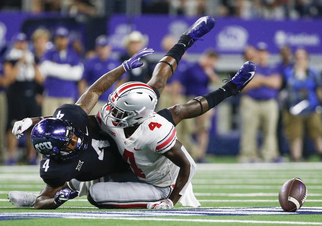 Ohio State safety Jordan Fuller breaks up a pass intended for TCU's Taye Barber during a game on Sept. 15. Fuller, the Buckeyes' second-leading tackler this season, also excels in the classroom. He was named a first-team Academic All-American last week. [Joshua A. Bickel/Dispatch]