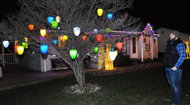 Jarred Sheppard, of 11 Grandview Road in Cambridge, has some unique large Christmas lights hanging from the tree in front of his home. For more pictures of Christmas decorations in the area, see Page C1 of this issue of The Daily Jeffersonian. Anyone who would like to submit a picture of their decorations can email them to newsroom@daily-jeff.com.