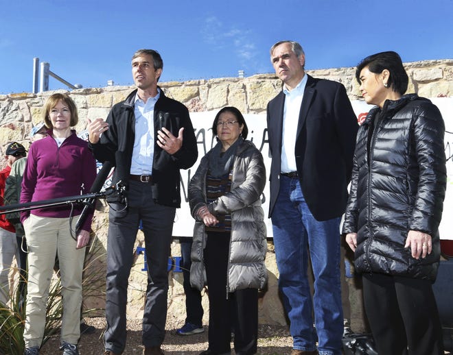U.S. Rep. Beto O'Rourke, D-El Paso, second from left, speaks with four other Democratic members of Congress after touring the Tornillo international port of entry where several thousand immigrant teens are being housed Saturday, Dec. 15, 2018, east of El Paso, Texas. With him are from left, Sen. Tina Smith, D-Minn., Sen. Mazie Hirono, D-HI, Sen. Jeff Merkley, D-Oregon and Rep. Judy Chu, D-Calif. (Rudy Gutierrez/The El Paso Times via AP)