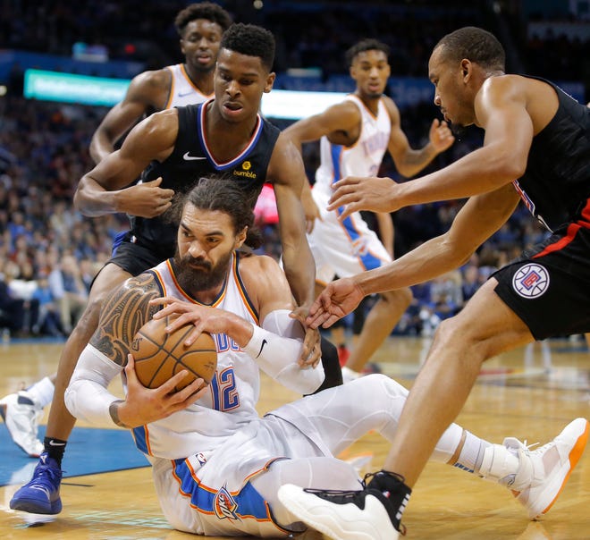Oklahoma City Thunder's Steven Adams (12) tries to gain control of the ball between Shai Gilgeous-Alexander (2) and Avery Bradley (11) of the Los Angeles Clippers during an NBA basketball game between the Oklahoma City Thunder and the Los Angeles Clippers at Chesapeake Energy Arena in Oklahoma City, Saturday, Dec. 15, 2018. Oklahoma City won 110-104. Photo by Bryan Terry, The Oklahoman